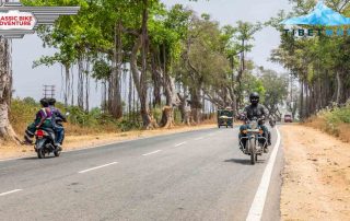 Motorrdfahrer fährt entlang einer Straße in Indien